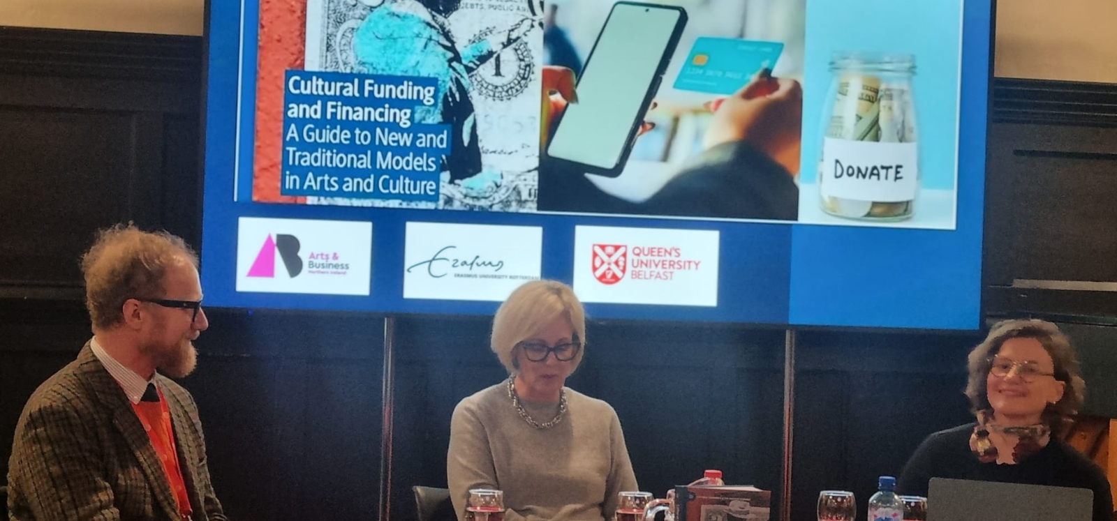 three people discussing book launch